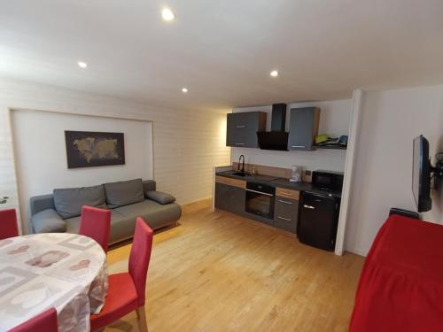 a living room with a couch and a table at Séjour dans la cité fortifiée in Colmars