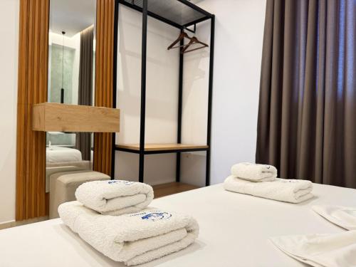 a pile of towels on a table in a room at Villa Bodini Himare in Himare