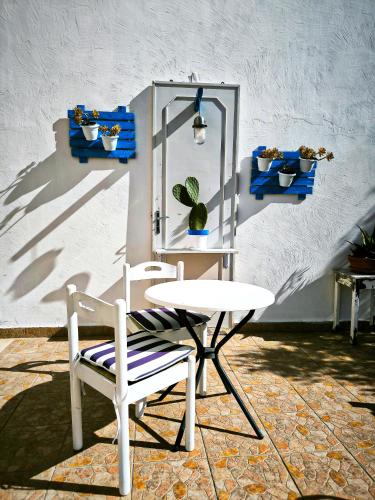 a white chair and a table and a plant at Tobia's House B&B in Giuggianello