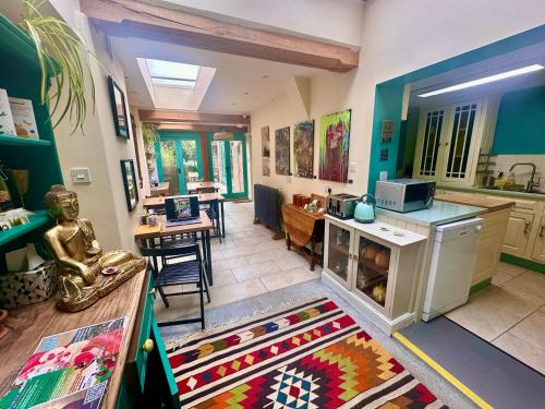 a room with a kitchen and a dining room at The Dragonfly Guesthouse - SELF CATERED in Glastonbury