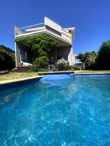 a house with a swimming pool in front of it at Guest Suite in Marino in Marino