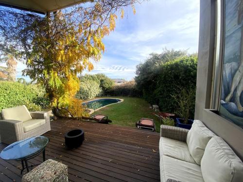 a patio with a couch and chairs on a deck at Guest Suite in Marino in Marino