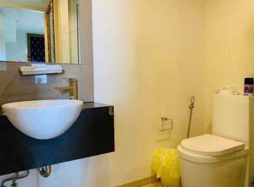 a bathroom with a white sink and a toilet at Condo Sea view Beach U14 in Pattaya South