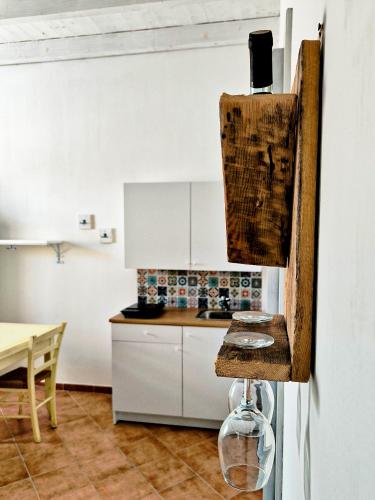 a kitchen with white cabinets and a counter top at Tobia's House B&B in Giuggianello