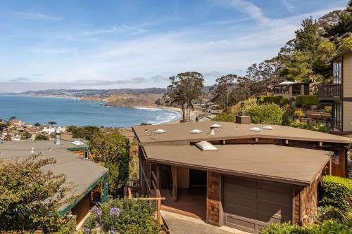a house on a hill with a view of the ocean at Small Home with Ocean View walk to Restaurants Brewery Shops Beach in Pacifica