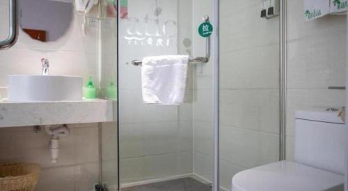 a bathroom with a shower and a toilet and a sink at Vatica Shanghai Jiading District Anting Metro Station Moyu Road Hotel in Shanghai