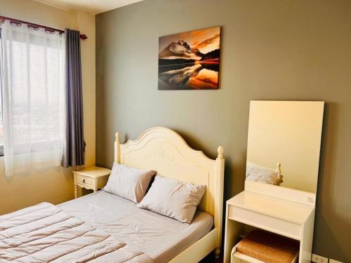 a bedroom with a bed with a white bed frame at Condo Sea view Beach U40 in Pattaya South