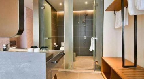 a bathroom with a shower and a bath tub at ibis xian North Second Ring Weiyang Rd Hotel in Xi'an