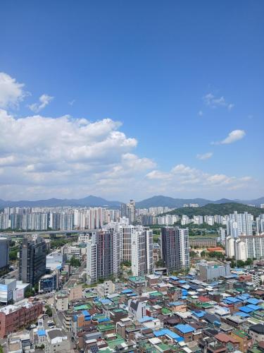 a city with tall buildings and buildings at The November Stay Guri Station in Guri