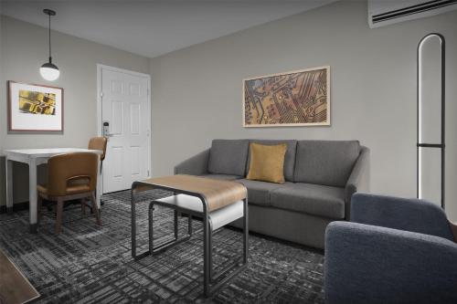 a living room with a couch and a table at Homewood Suites by Hilton San Jose Airport-Silicon Valley in San Jose