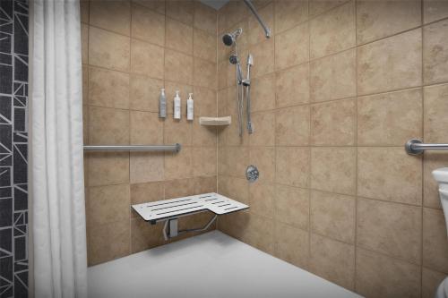 a bathroom with a shower with a toilet and a sink at Homewood Suites by Hilton San Jose Airport-Silicon Valley in San Jose
