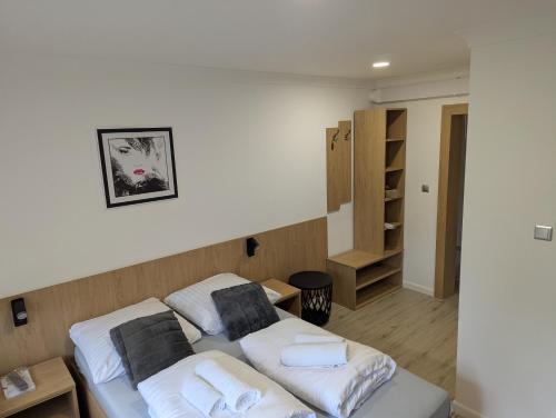 a room with two beds with towels on them at Noclegi pod gora in Oboźna Droga Masłów