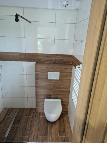 a small bathroom with a toilet in a room at Noclegi pod gora in Oboźna Droga Masłów
