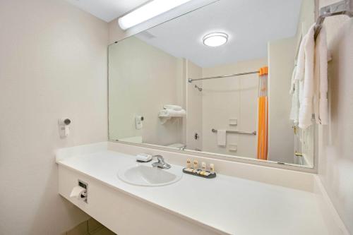 a bathroom with a sink and a large mirror at La Quinta by Wyndham DFW Airport South / Irving in Irving