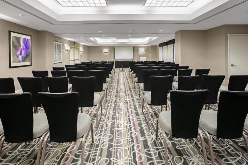 a conference room with chairs and a projection screen at La Quinta by Wyndham DFW Airport South / Irving in Irving