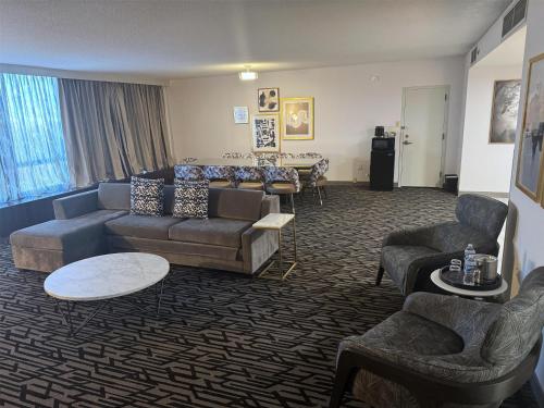 a living room with a couch and chairs and a table at DoubleTree by Hilton Cherry Hill Philadelphia in Cherry Hill