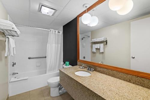 a bathroom with a sink and a shower and a toilet at Quality Inn Bangor Airport in Bangor