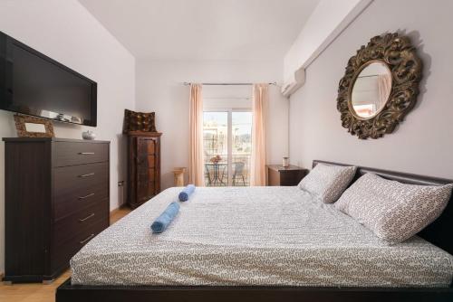 a bedroom with a bed with a blue teddy bear on it at Amazing apartment 300 meters from the Old Town in Rhodes Town