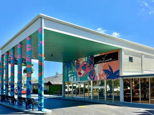 a building withspectacular paintings on the side of it at enVision Hotel Miami International Airport in Miami