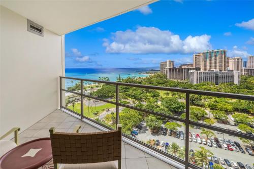 a balcony with a view of the beach and the ocean at Ka Laʻi Waikiki Beach, LXR Hotels & Resorts in Honolulu