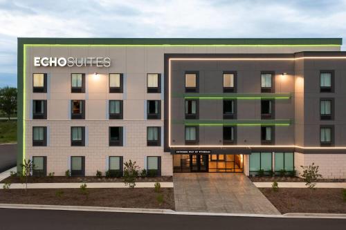 a rendering of the exterior of an apartment building at ECHO Suites Extended Stay by Wyndham Indianapolis AmeriPlex in Indianapolis