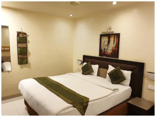 a bedroom with a large bed in a room at A Premium Hotel FAIRWAY Near Railway Station - Well Decorated & Spacious Rooms - Lift # Restaurant # Free Parking And Free Wi-fi Available - A Top Rated Hotel In Amritsar in Amritsar