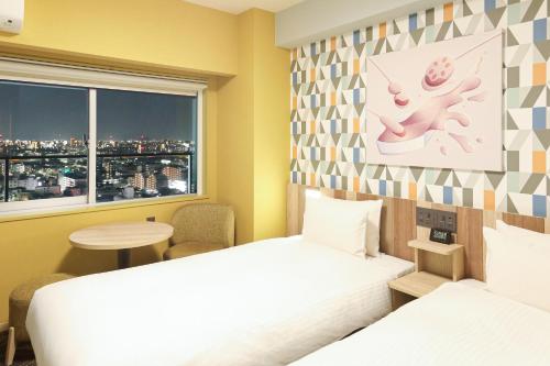 a hotel room with a bed and a window at Hiyori Hotel Osaka Suminoekoen Station in Osaka