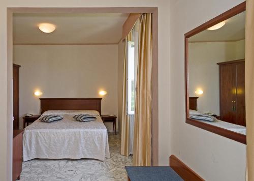 Postel nebo postele na pokoji v ubytování Hotel Coluccini