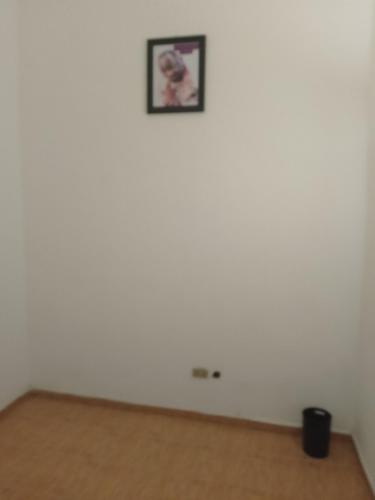 a room with a white wall with a picture on it at Peace Home in Lekki