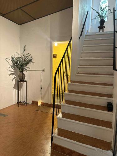 a hallway with stairs and a yellow door at Ananda Home in Tân Hiệp