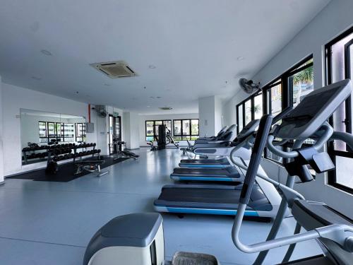 a gym with a row of treadmills and machines at Doraemon I-City House, Hyde Tower I-City, Seksyen 7, Shah Alam, Selangor in Shah Alam