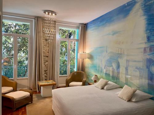 a bedroom with a large painting on the wall at Le Windsor, Jungle Art Hotel in Nice