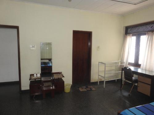 a room with a room with a desk and a bed at Serenity in Kandy