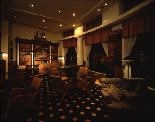 a large living room with chairs and a couch at Hotel The Manhattan in Chiba
