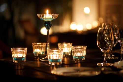 a table with glasses and a candle on it at Hotel The Manhattan in Chiba