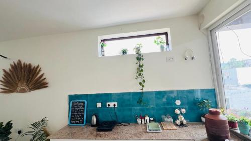 a kitchen counter with a chalk board and a window at Dhyani Residence in Nakraunda