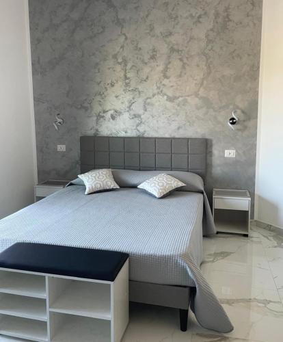 a bedroom with a large bed with two night stands at B&B Ilary Tropea in Tropea