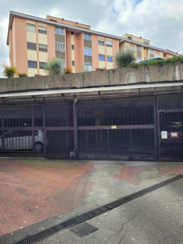 an open gate in a parking lot in front of a building at Panoramico Eur in Rome