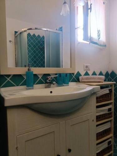 a bathroom with a sink and a mirror at Libra Luxury Holidays in Baja Sardinia