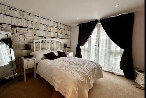 a bedroom with a large bed and a window at Number 2 Lymington Hampshire in Lymington