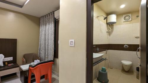 a small bathroom with a toilet and a sink at HOTEL BINAPANI Deluxe 1 in Tarapith