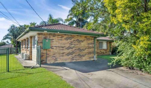 a brick house with a gate in the driveway at 3 Bed House free parking,Master with AC in Browns Plains