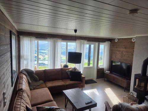 a living room with a couch and a flat screen tv at Apartment Tråstølen ski in ski out in Vossevangen