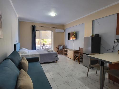 a living room with a couch and a bed at GM Apartments in Tolo