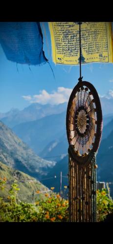 a fan hanging from the top of a umbrella at Gaonvasi Homestay in Uttarkāshi