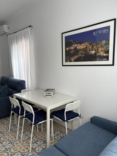 a white table and chairs in a living room at Casa Azul in Málaga