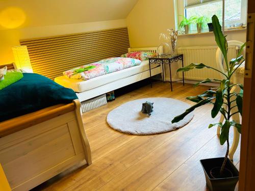 a bedroom with a bed and a dog on a rug at Ferienwohnung "Bei Freunden" in Naumburg