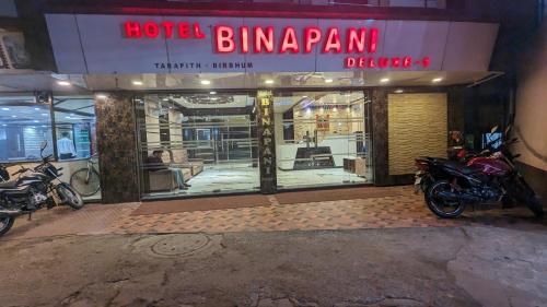 a hotel building with motorcycles parked outside of it at HOTEL BINAPANI Deluxe 1 in Tarapith