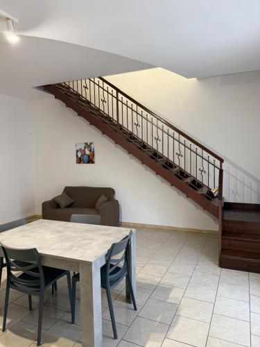 a living room with a table and a staircase at Casa Marconi in Paterno