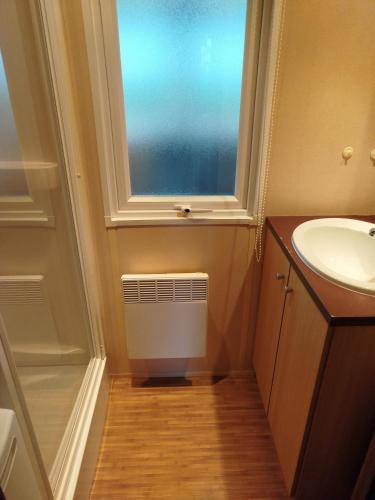 une salle de bain avec un lavabo et une fenêtre dans l'établissement La réserve, à Gastes